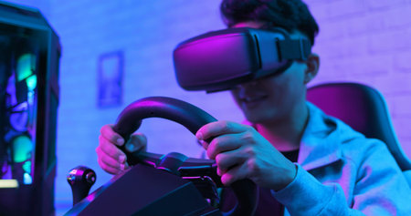 asian gamer play car racing game with wearing vr glasses