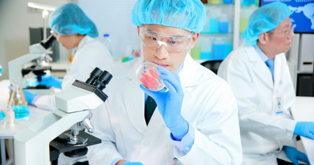 asian scientist team meeting and writing analysis results in the laboratory
