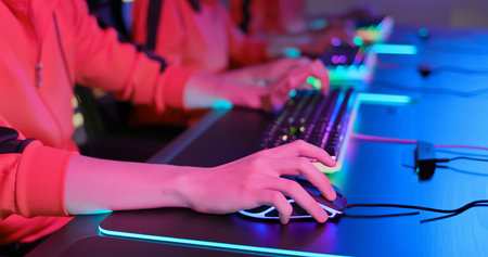 close up of pro cyber sport gamers play game with RGB keyboard and mouse