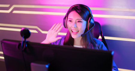 Young Asian Pretty Pro Gamer having live stream and playing in Online Video Game