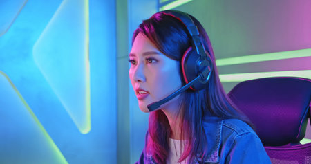 close up of Young Asian Pretty Pro Gamer Playing in Online Video Game