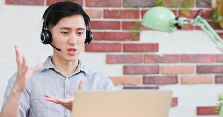 Smart asian young male student use ear bud to study something at online courses and make discussion...
