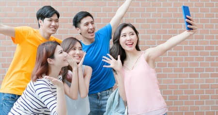 group happy graduates students use diploma to high fiveの写真素材