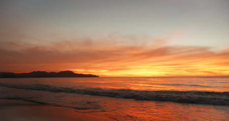 the evening sun with a beautiful light at the seasideの写真素材