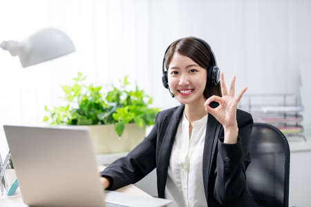 asian customer service representative working in the officeの写真素材