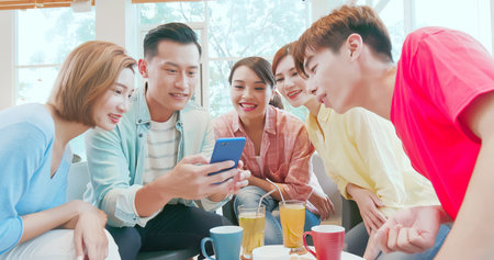 close up of happy young asian teenagers share an interesting APP on smartphone and they feel very...