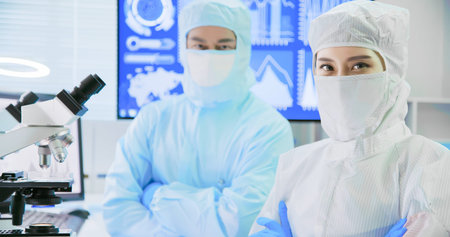 asian biological technology scientist team watch something on petri dish in the laboratory