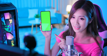 close up of asian woman use smartphone outdoor with face mask while commuting at nightの写真素材