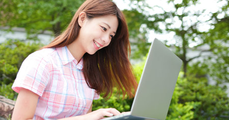 College student use laptop to do the assignment on campusの写真素材