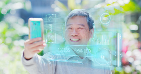 old man use smart phone unlocking with biometric facial identification outdoor