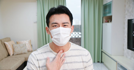 Telemedicine concept-asian young male patient wears facial mask and describe his health condition to...