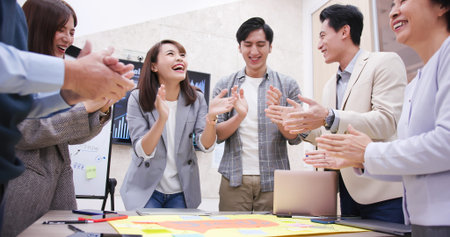 Group of businessmen standing around the table and successfully complete the project discussion