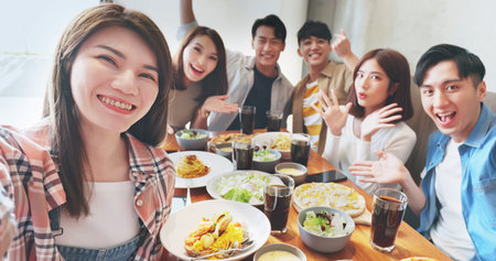 asian young six friends taking selfie in restaurant happily