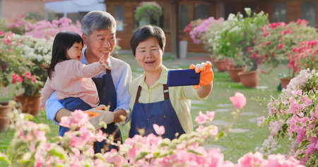 Authentic shot of asian retired grandparent have video chat on smart phone with their granddaughter...