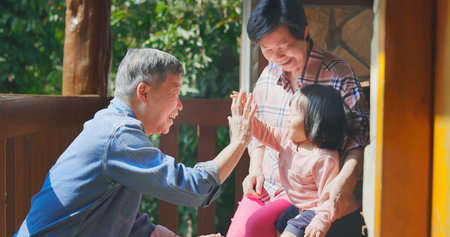 Authentic close up of asian senior retired grandparent have fun with their granddaughter while travelingの写真素材