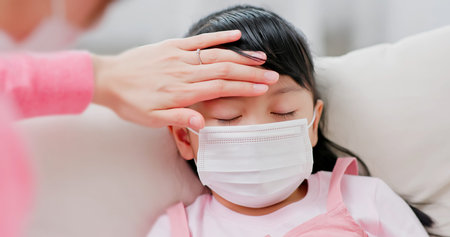 Mom use ear thermometer to measure kids temperature