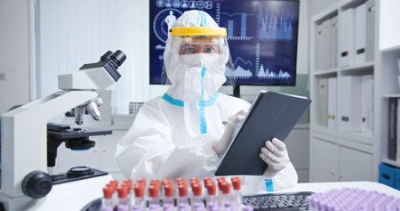 asian doctors who is wearing isolation gown or protective suits and surgical face masks has video...