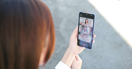 Asian businessswoman has video conference outside the officeの写真素材