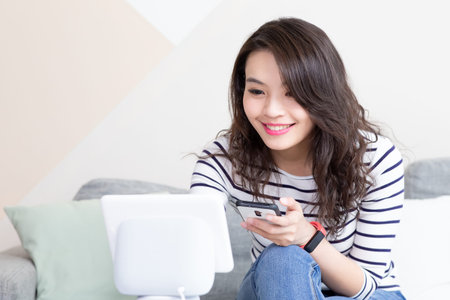 Smart AI speaker concept-Asian woman tell voice assistant to control smarthome