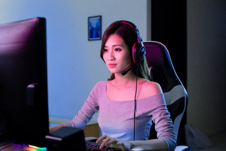 Young Asian Pro Gamer Girl Playing in Online Video Game at homeの写真素材