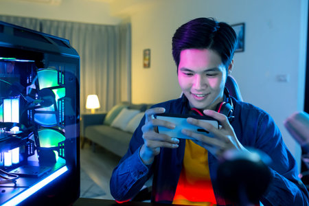 Asian cyber sport gamer have live stream and playing mobile game on the smartphone at home