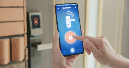 Smart home concept-close up of asian woman use mobile phone to open electronic lockの写真素材