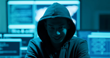 Asian male hacker smile and look at you