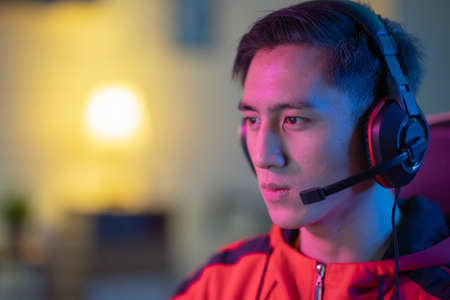 close up of Young Asian Handsome Pro Gamer Playing Online Cyber Sport Game at homeの写真素材