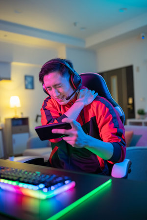 Young asian esport gamer has shoulder pain while playing in Online Video Game