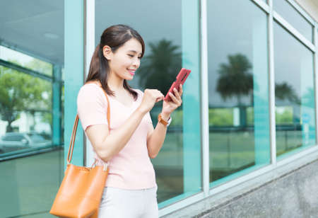 asian woman is using smart phone while commutingの写真素材
