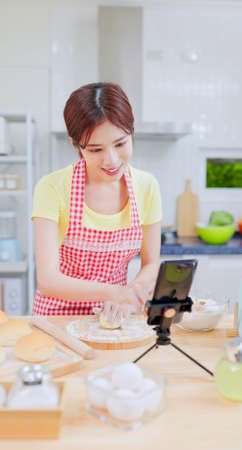asian prettey housewife use tablet to learn for cooking on internet of smartphoneの写真素材