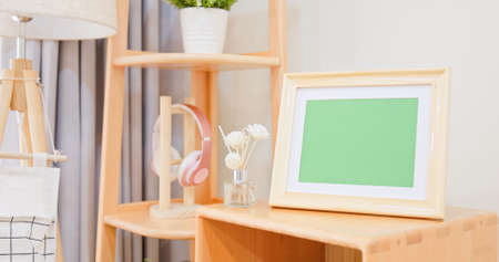 close up of photo frame with green copy space on cabinet in living room at homeの写真素材