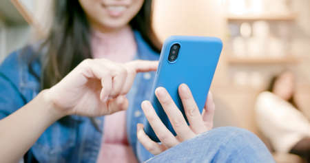 close up of asian woman use smartphone in restaurantの写真素材