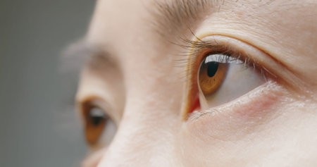 macro shot of brown eye with pupil and iris