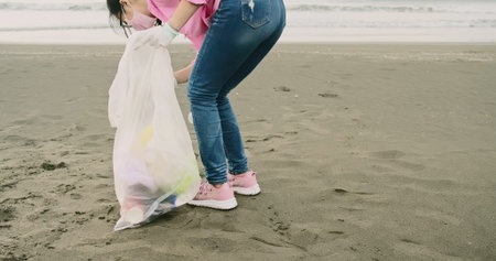 asian female volunteer keep clean on the beachの写真素材