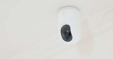 close up of surveillance cameras on ceiling at homeの写真素材