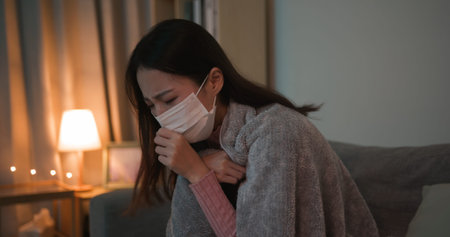 side view of asian woman sick and cough in the living room at home