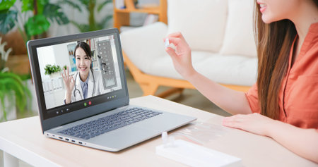 telemedicine concept-close up of asian woman talking to female doctor online and showing antigen...