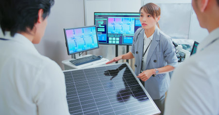 asian woman team leader have meeting and discussing solar panel projects with colleagues in officeの写真素材