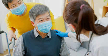asian senior man who uses a wheelchair with wife accompany and female doctor taking care of him at...