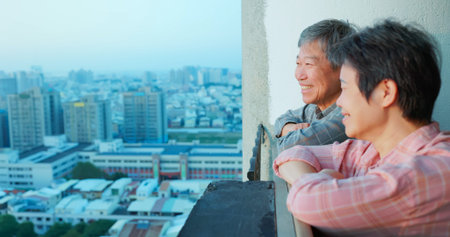 close up of senior asian couple looking outside from homeの写真素材