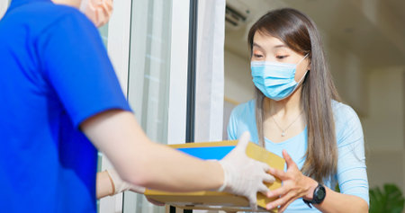 asian female wear mask receive medication package box from pharmacy hospital delivery service at...
