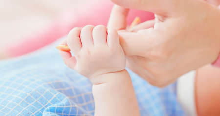 authentic shot of baby hand gently holding finger in close upの写真素材