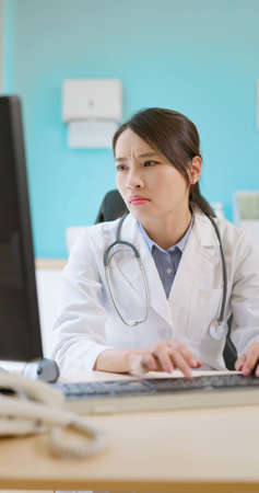 asian female doctor physician has stress because of overworked in hospital and she feel depressの写真素材