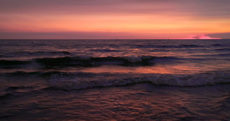 wave or tide changes in sunset on the beach