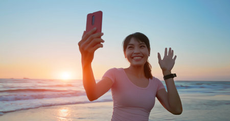 silhouette of Asian healthy woman is practicing yoga and meditation on beach in the dusk