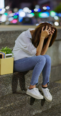 asian business woman speaks on smartphone while commuting by taxi at nightの写真素材