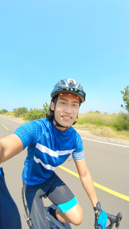 close up of asian man ride a bicycle on countryside happilyの写真素材