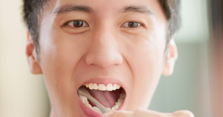 Close up - Asian man brushing teeth in bathroom