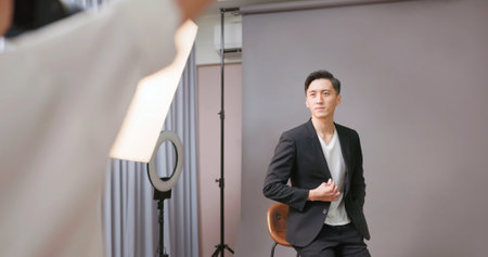 Female Asian photographer shooting photo of male modelの写真素材